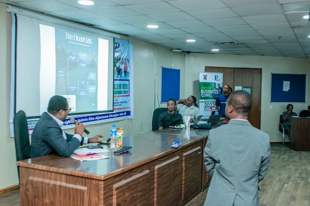 Clinic founder pitching financial strategy and business model to panel in conference hall