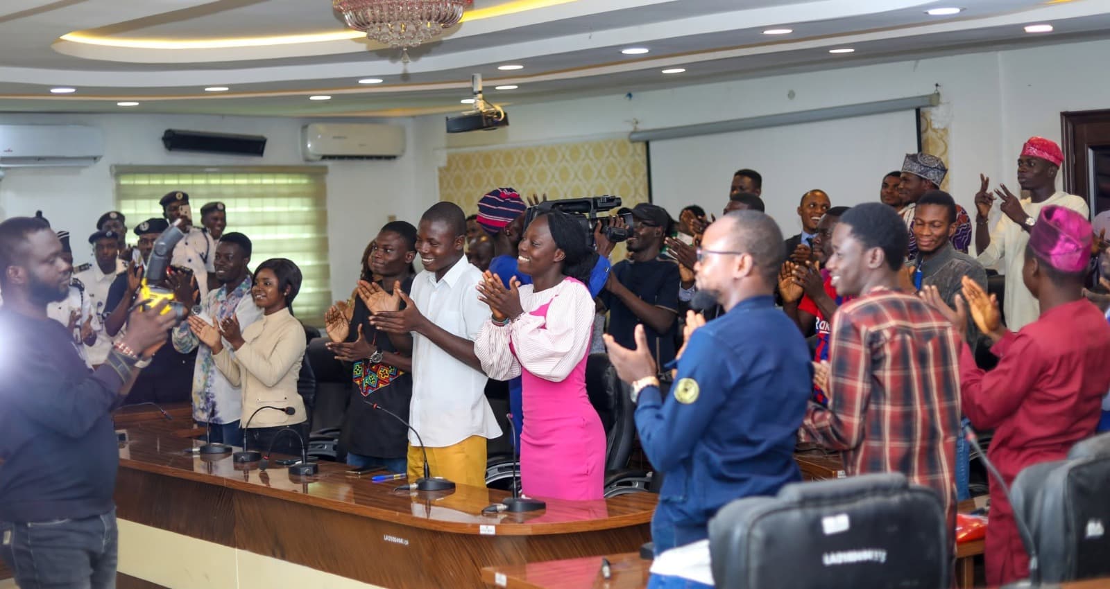 Participants and officials applauding at the close of a cohort