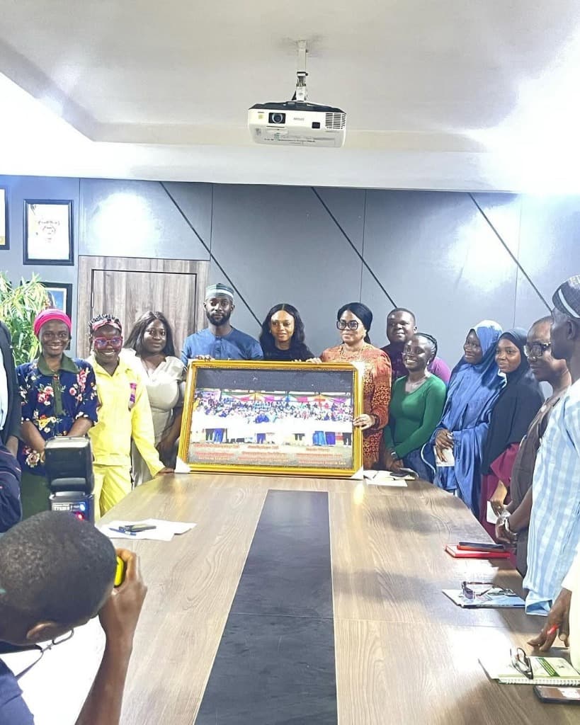 Programme leadership, Ministry officials, and cohort entrepreneurs presenting commemorative cohort photograph in boardroom